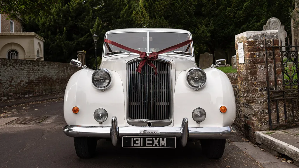 Front view of Classic Austin Princess Limousine decorated with Burgundy Ribbons