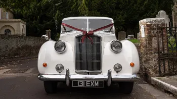 Front view of Classic Austin Princess Limousine decorated with Burgundy Ribbons