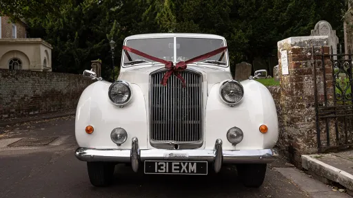 Front view of Classic Austin Princess Limousine decorated with Burgundy Ribbons