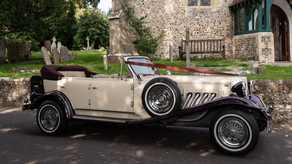 Side view of Ivopry Beauford dressed with Burgundy Ribbons in Front of a church