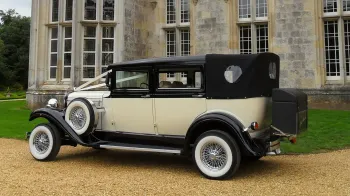 Rear view of Vitange Branford in Ivory with Black Convertible Roof closed, white wall tires and white ribbons
