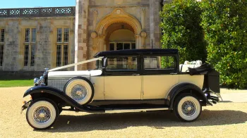 Black & Ivory Vintage car dressed with white ribbons  and convertible roof open