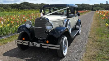Front view of Vintage Branford decorated with white ribbon, chrome grill and old fashion headlights