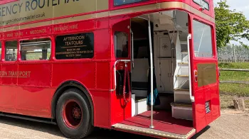 View of the Rear open platform with chrome pole in the middle and stairs to the upper deck