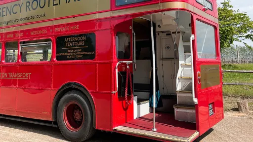View of the Rear open platform with chrome pole in the middle and stairs to the upper deck