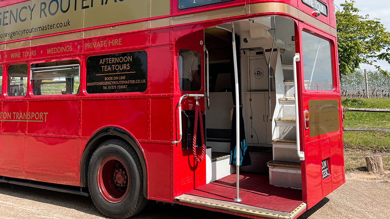 View of the Rear open platform with chrome pole in the middle and stairs to the upper deck