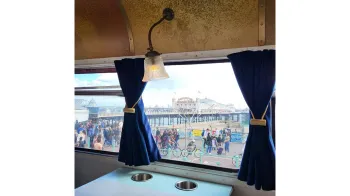 interior lighting over the windows looking outside through the window onto a very busy beach