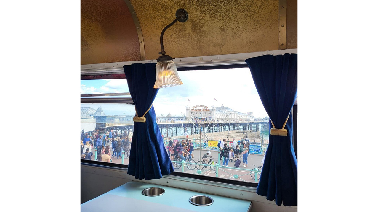 interior lighting over the windows looking outside through the window onto a very busy beach