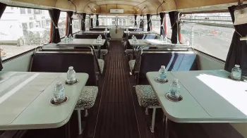 lower decker seating area with bench seats and tables