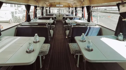 lower decker seating area with bench seats and tables
