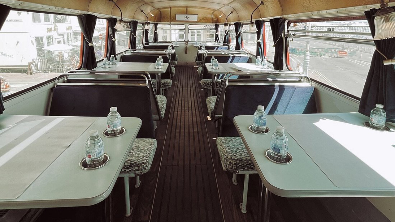 lower decker seating area with bench seats and tables