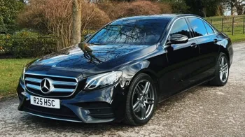 Left front View of Black Mercedes with chrome wheels and chrome grill