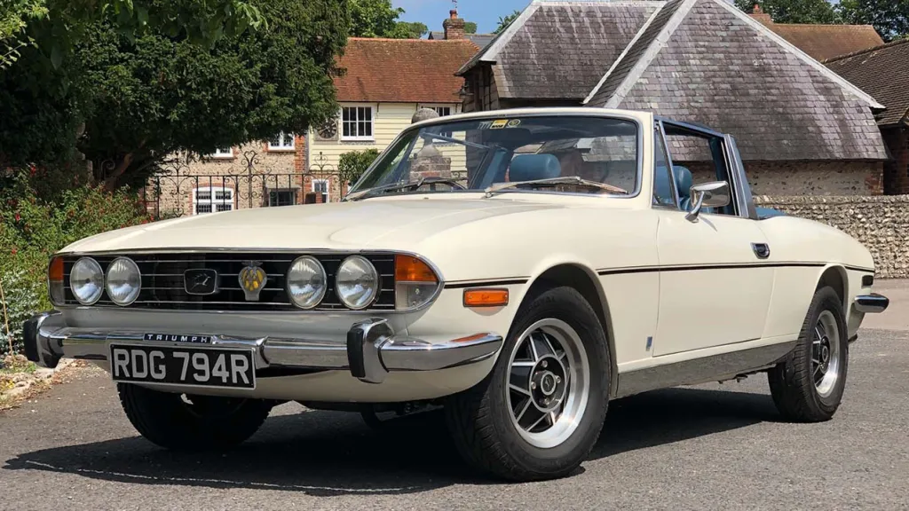 Left Side view of a classic stag with convertible roof down