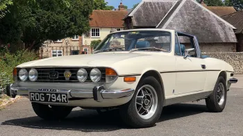 Left Side view of a classic stag with convertible roof down