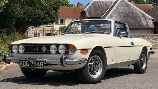 Left Side view of a classic stag with convertible roof down
