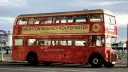 Red Routemaster bus on Brighton Sea Front showing a busy pier in the Background