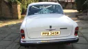 Rear view of Classic Rolls-Royce Silver shdaow showing the posy of wedding flowers on the parcel shelf through the rear window