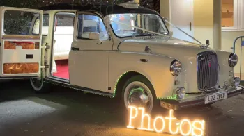 Classic Taxi Cab with illuminated rear inside cabin and photo sign at the front