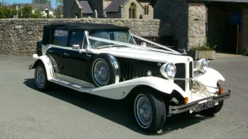 Left side view showing the spare mounted wheel on the wheel arch and Convertible soft top Black roof closed