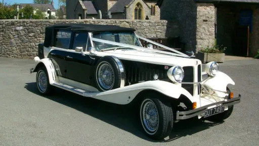 Left side view showing the spare mounted wheel on the wheel arch and Convertible soft top Black roof closed