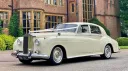 Left side view of Classic Rolls=-Royce in front of wedidng venue