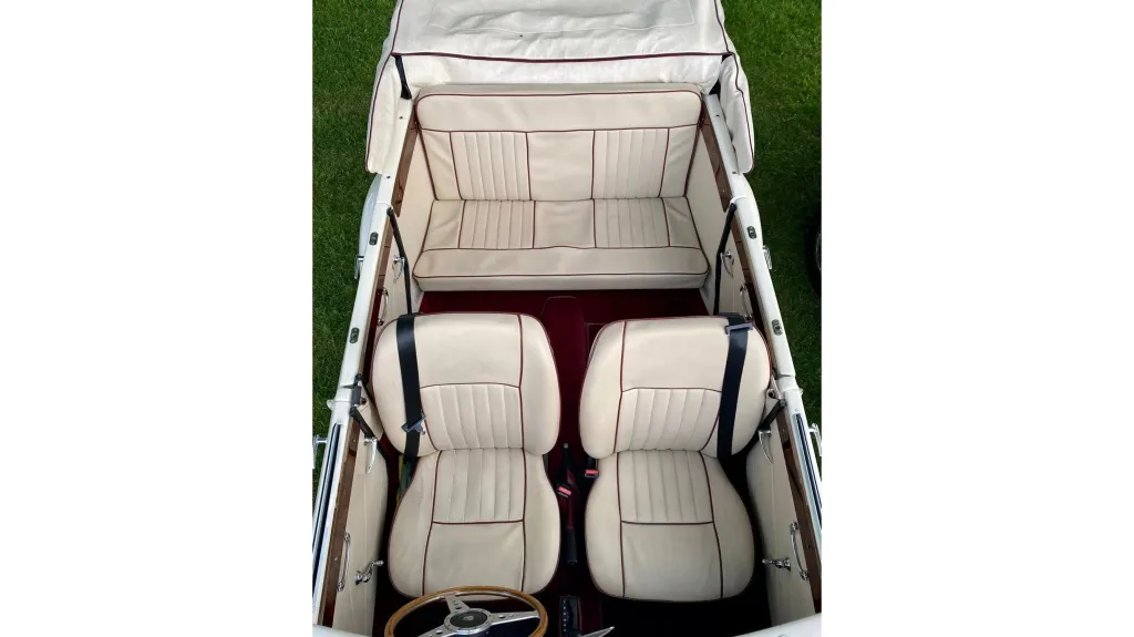 interior of a Convertible Beauford showing Cream Leather interior and Burgundy Carpet.