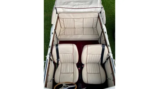 interior of a Convertible Beauford showing Cream Leather interior and Burgundy Carpet.