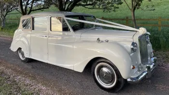 Side view of classic austin Princess Convertible showing the closed up cream soft-top roof