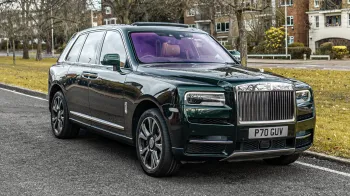 Dark Green Rolls-Royce cullinan right front view sitting in the street of london