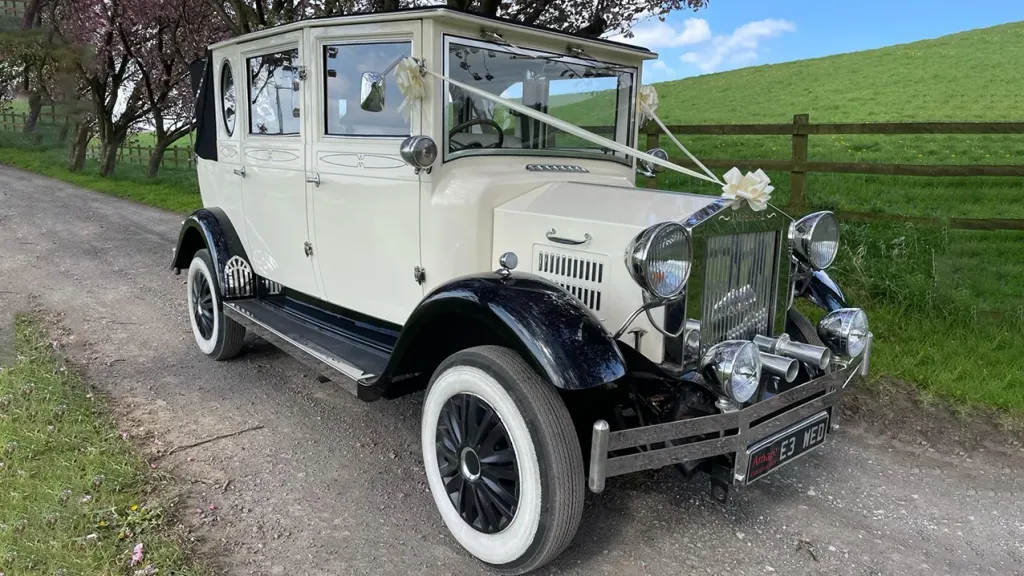 Right front view of Viontage bramwith landaulette, white ribbons and bow on front bonnet , black wheel arches and white wall tires