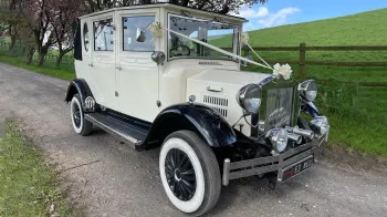 Right front view of Viontage bramwith landaulette, white ribbons and bow on front bonnet , black wheel arches and white wall tires