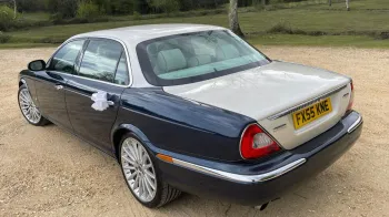 Left side view of Daimler V8 showing large chrome alloy wheels and large white bow on the rear passenger door handle