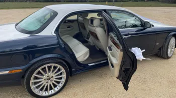Right side photo of the Daimler with Rear Driver Door open showing Cream leather interior and large legroom space.