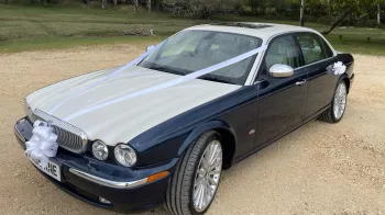 Left view of Daimler Super V8 showing large alloy wheels, white bonnet and sunroof