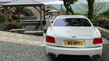 Full rear View of White Bentley Flying Spur