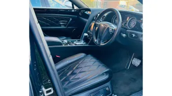 Front interior view of Bentley showing Black Leather interior, Front Dashboard and steering wheels