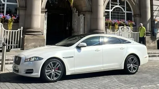 Left Side View of White Jaguar in front of wedding venue in Manchester