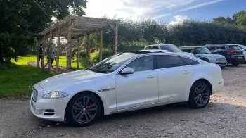 Left view of White Jaguar XJ with Large Chrome Alloy Wheels