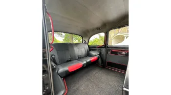 Rear cabin interior of Taxi Cab with grey interior and grey carpet