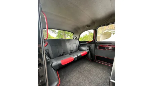 Rear cabin interior of Taxi Cab with grey interior and grey carpet