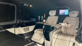 interior of Mercedes customized by Driven showing cream leather interior and large TV