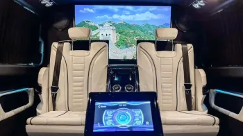 interior of Mercedes customized by Driven showing cream leather interior and large TV
