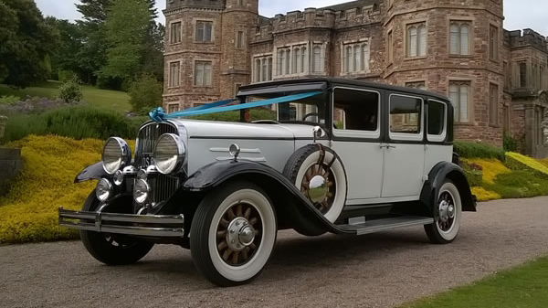 Vintage Franklin dressed with Turquoise blue ribbons in front of wedding venue
