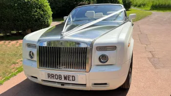 White Rolls-Royce Phantom Drophead with silver bonnet decorated with white ribbon