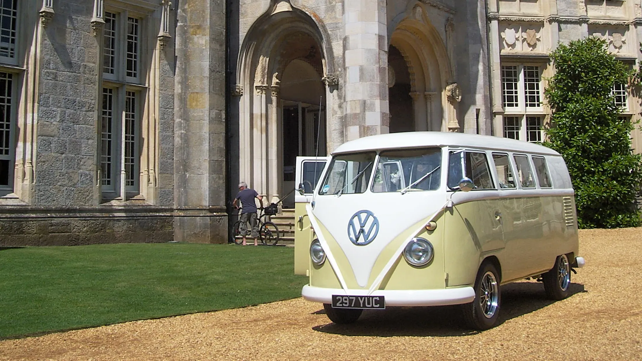 Retro Classic Volkswagen Campervan decorated with white ribbons at a local Sherborne wedding venue.