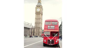 Front view of Routemaster bsu with white ribbon and Elizabeth's Tower in the Background