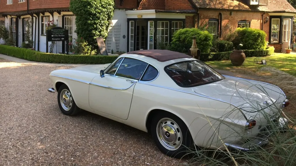 Ivory Classic volvo parked in front of a wedding venue