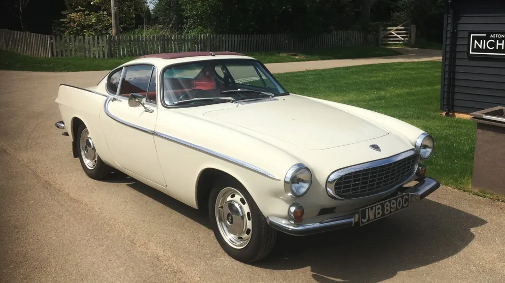 Front view of Classic Volvo in Olde English White with burgundy webasto roof