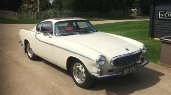 Front view of Classic Volvo in Olde English White with burgundy webasto roof