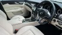 Front Passengers eating area in a White Mercedes. Seats are in cream leather with matching cream door cards.